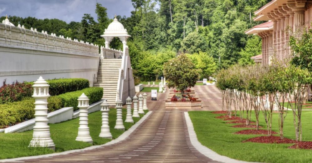 Garden - Concrete Hallway Between White Pillars and Building