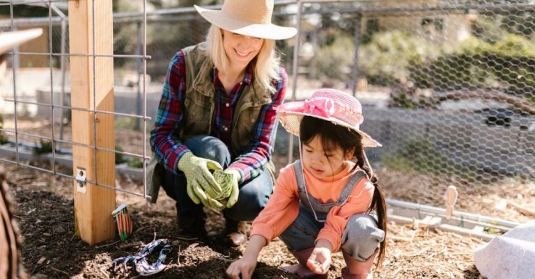 Mulch - Woman and a Child Planting Seeds on the Ground