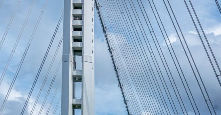 Areas - A large white bridge with a cloudy sky