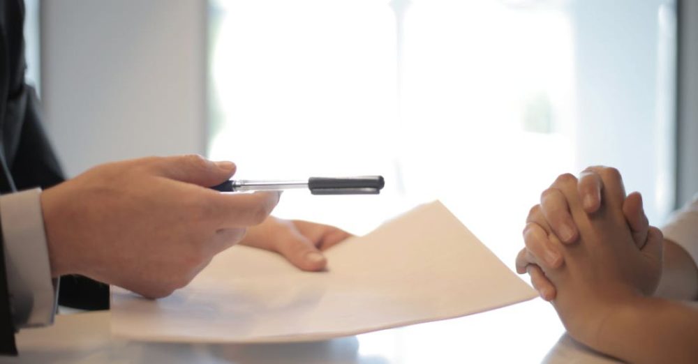 Policies - Crop businessman giving contract to woman to sign