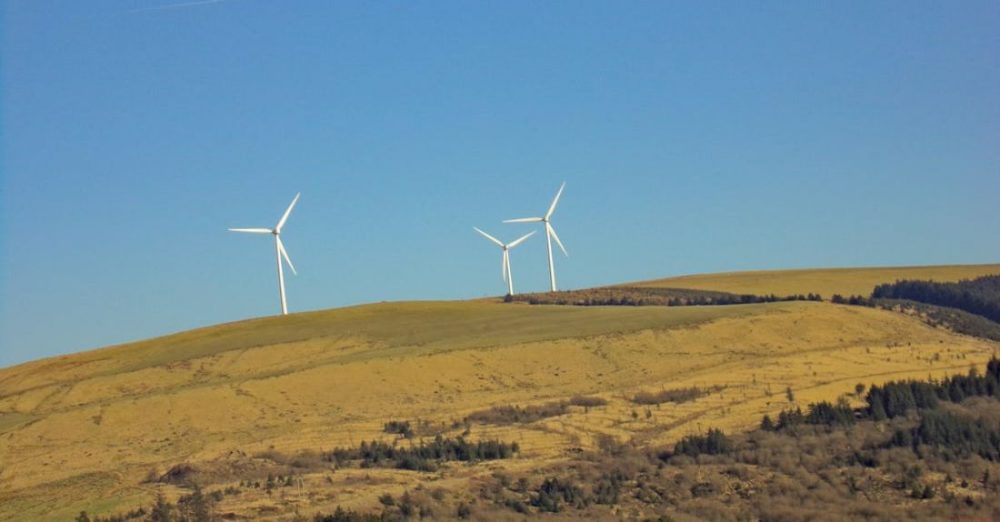 Conservation - Three White Windmills on Green Field Under Blue Sky