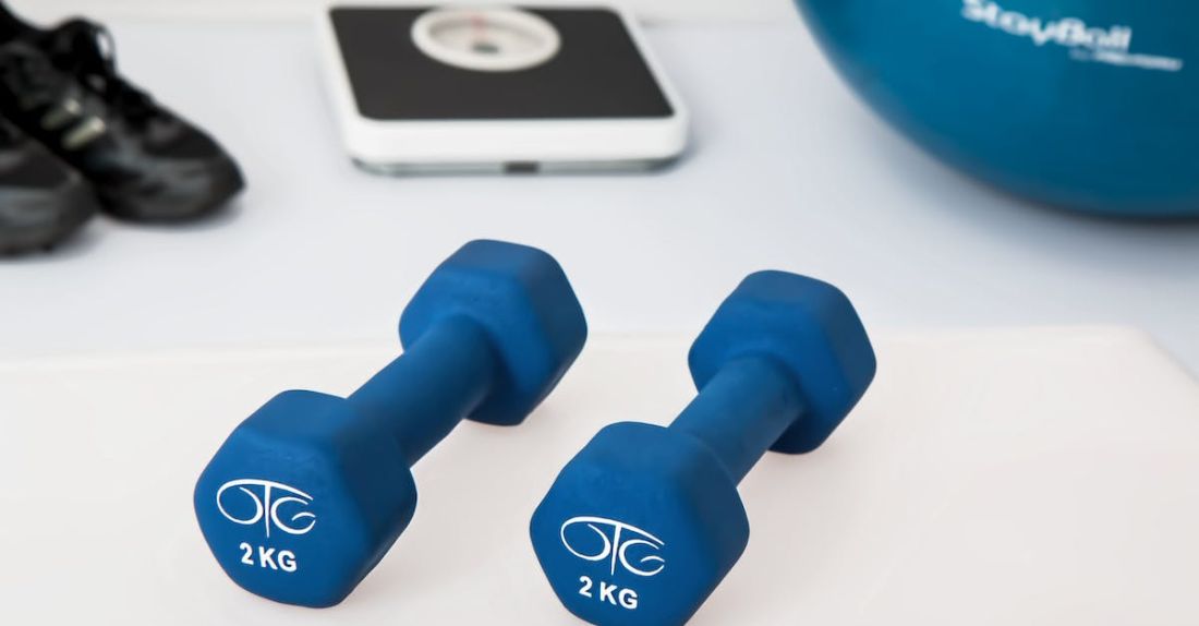 Rehabilitation - Two 2 Kg. Blue Hex Dumbbells on White Surface